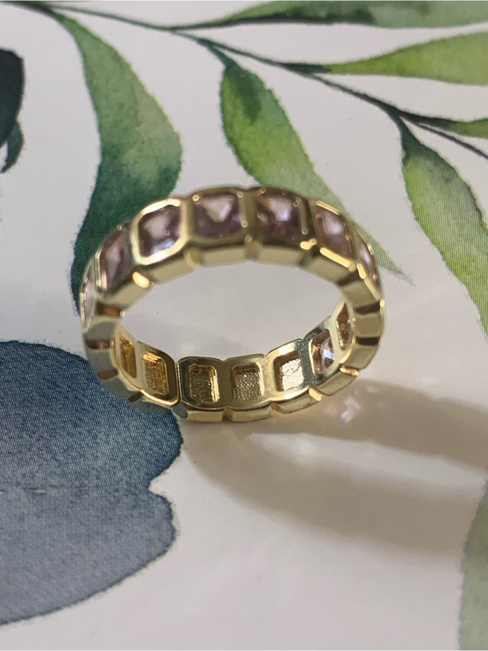 Gold Plated Ring Has Multiple Emerald Cut Amethyst Gems in a Round Band Shape